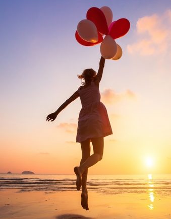 imagination, happy girl jumping with multicolored balloons at sunset on the beach, fly, follow your dream